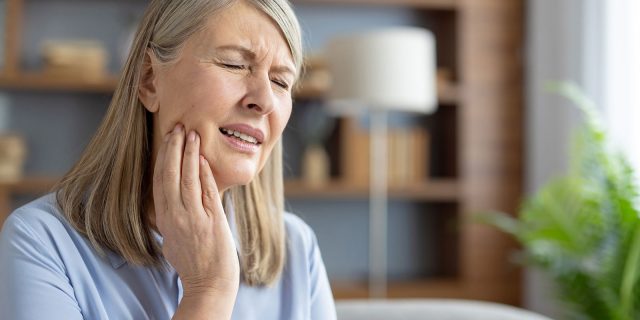 older woman with mouth pain