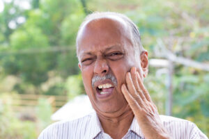 man experiencing tooth pain